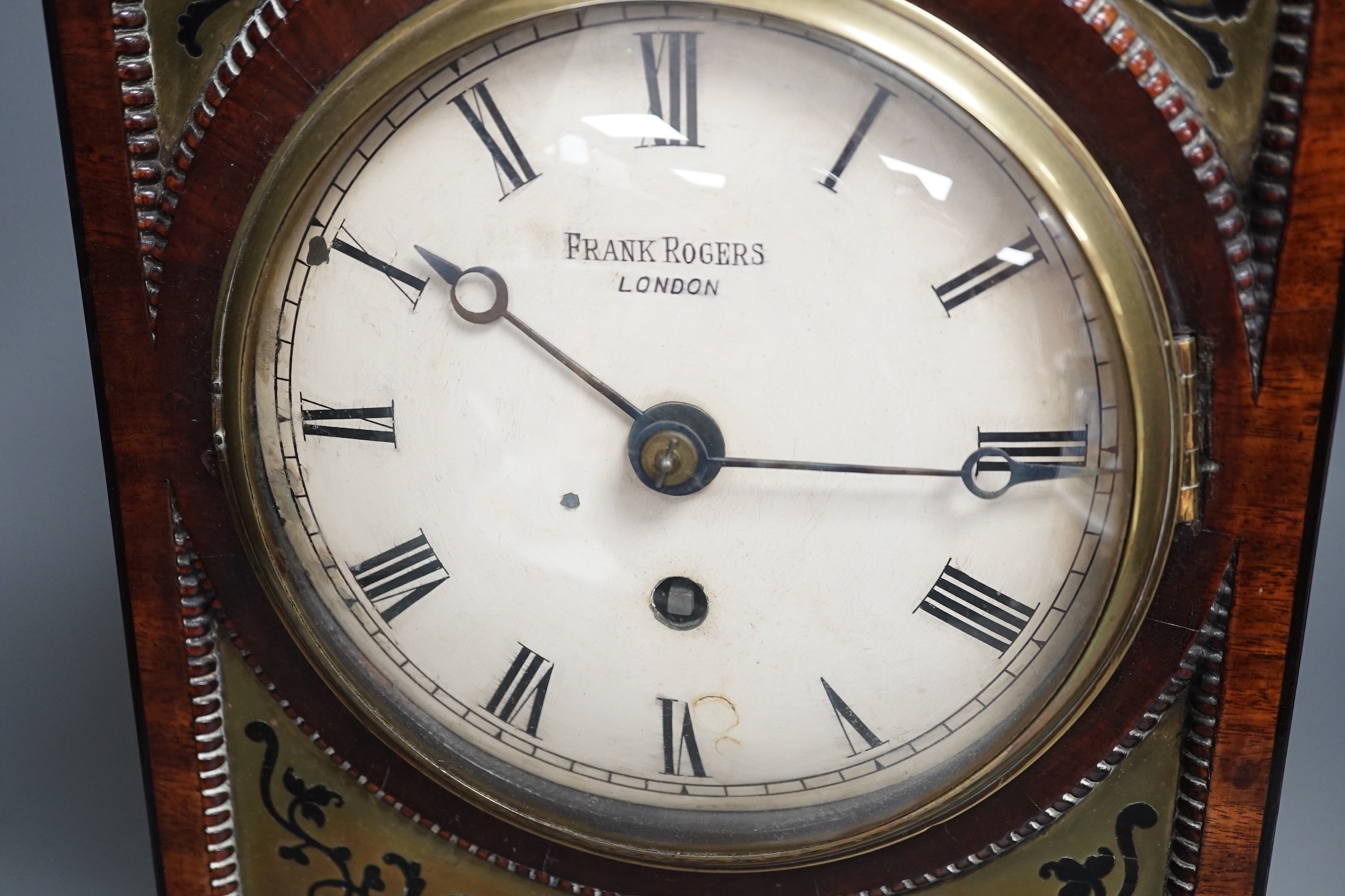 A Regency cut brass inlaid mahogany bracket timepiece by Frank Rogers, 46cm tall